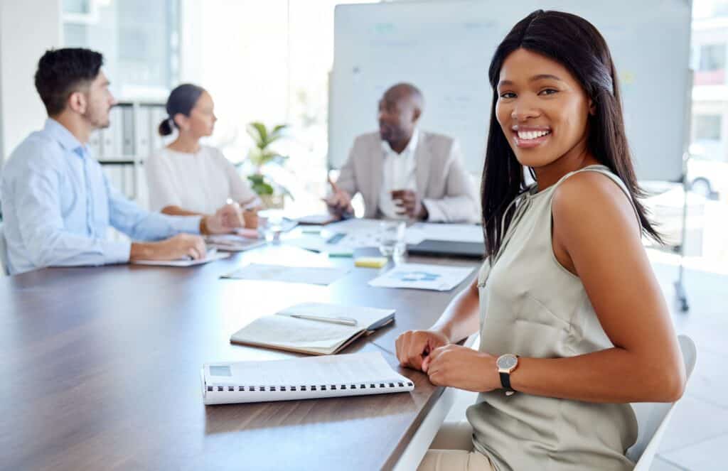 Happy black woman, leadership or business leader in meeting for teamwork, diversity or team buildin