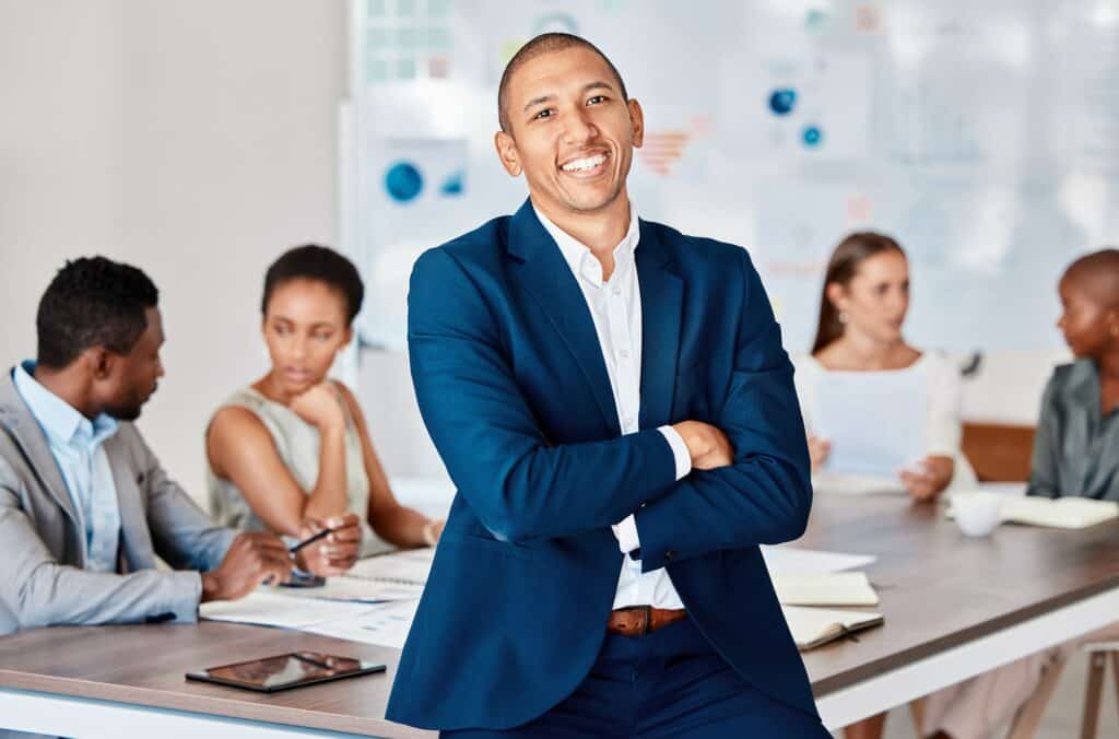 Leadership, success and teamwork, a businessman in a meeting in an office boardroom, with a smile.